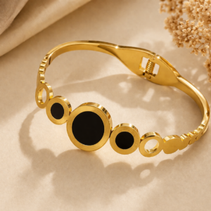 Gold anti-tarnish bracelet with black circular inlays and Roman numeral detailing, featuring a sleek linked design and secure clasp.